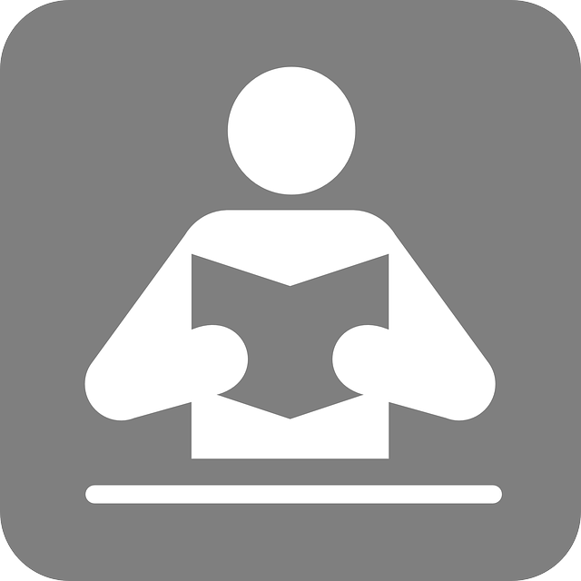 Obraz przedstawia ikonę czytelnika z książką w dłoniach