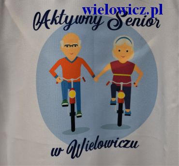 Plakat przedstawiający parę seniorów na rowerach z napisem Aktywny Senior w Wielowiczu